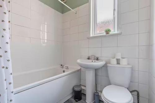 a white bathroom with a toilet and a sink at Coventry Contractor Hub - 4-Bedroom House with Free Parking-CV5 in Spon End