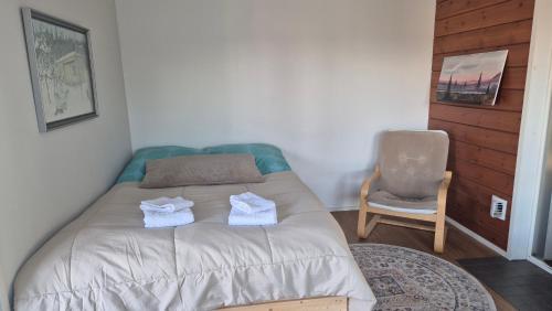 a bedroom with a bed with two towels on it at Saunatupa Kajaani in Kajaani