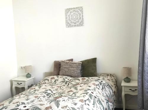 a bedroom with a bed and two night stands at Parkside Home in Törökbálint
