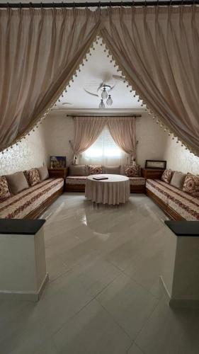 a large living room with couches and a table at Résidence Talhaoui in Saïdia