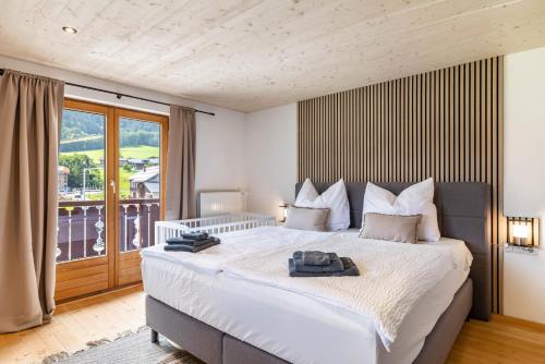 a bedroom with a large bed and a large window at Haus Helena Sophia in Au