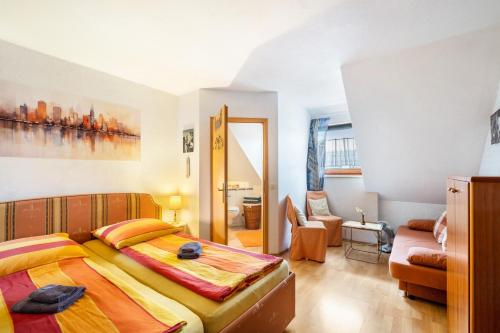 a bedroom with a bed and a living room at Reihenhaus Römmer in Altenstadt