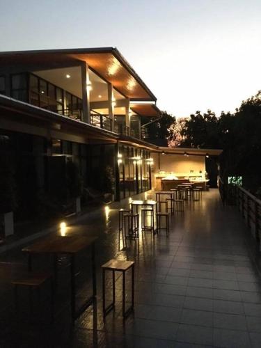 a building with tables and chairs in front of it at Pagoda Sight Residence in Nan