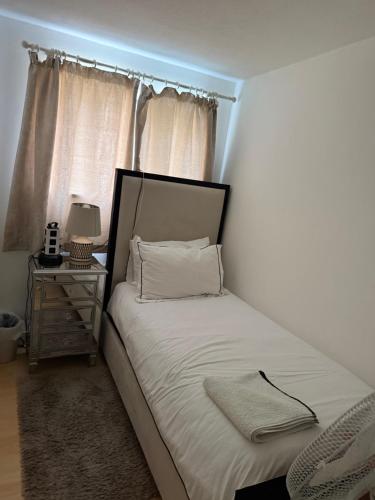 a small bedroom with a bed with a window at Pendleton in Peterborough