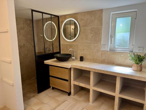 a bathroom with a sink and a mirror at Bastide du Buou in Puyvert
