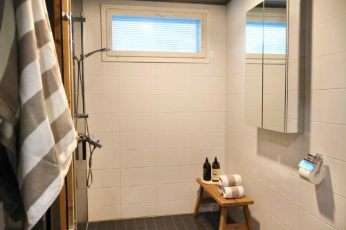 a bathroom with a shower with a toilet and a window at Villa Lydia Lapland - Private Sauna & Aurora View in Rovaniemi