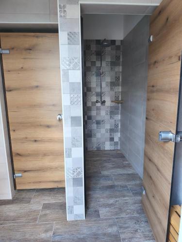 a shower with a glass door in a bathroom at Pr' Končovc - wooden tent in Kranj