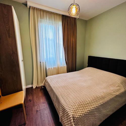 a bedroom with a bed in front of a window at "Mtis broli 77"-Mzetamze-Borjomi in Mzet'amze