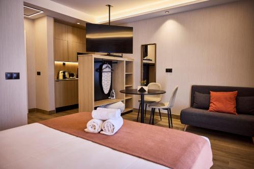 a bedroom with a bed and a couch and a table at Medichë Rooms General Ricardos in Madrid