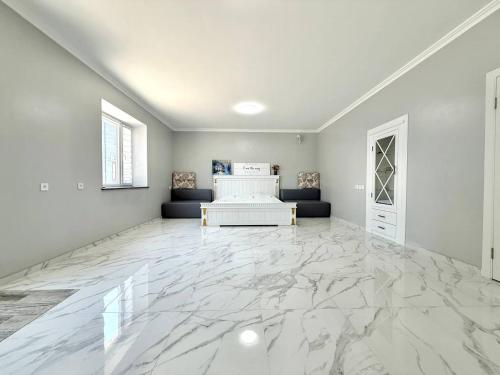 a large white room with a marble floor at Apartment HOME две спальни in Reni