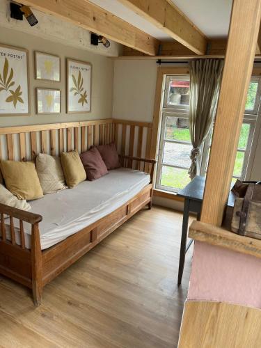 a bed in a room with a large window at Große Auszeit im Tiny House in Schashagen