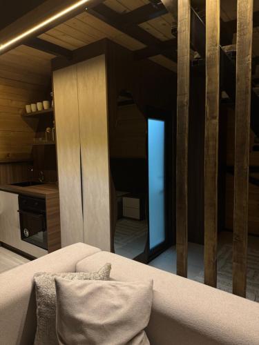 a living room with a couch and a kitchen at LiLo s Villa in Ferizaj