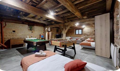 a room with a bed and a pool table at Authentic Residence from 1792 - Caujac in Caujac