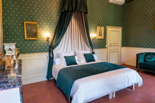 a bedroom with a bed in a room with green wallpaper at Château de Mons Gard in Mons