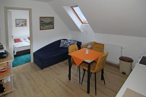 a living room with a table and a blue couch at Apartmá Jablonec in Jablonec nad Nisou