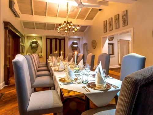 a dining room with a long table with chairs at Blue Mountain Estate in Hazyview