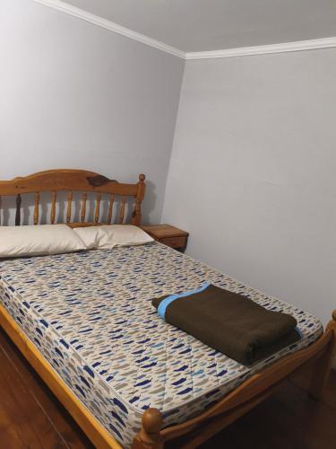 a bedroom with a bed with a wooden head board at El Rancho del Tucu in Colón