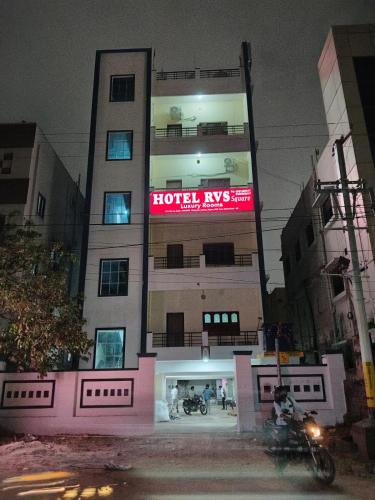 a building with a sign on the side of it at Hotel 9 square in Shamshabad