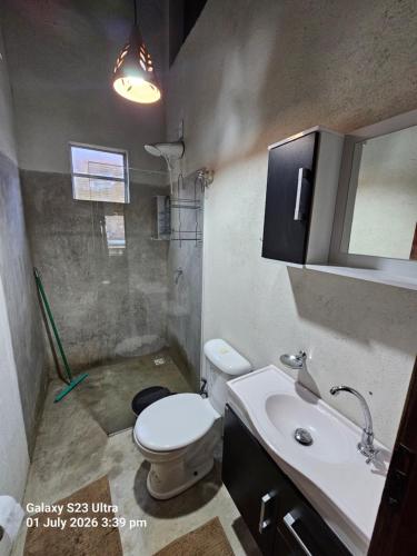 a bathroom with a toilet and a sink and a shower at Sito Marinheiro in Porto Seguro
