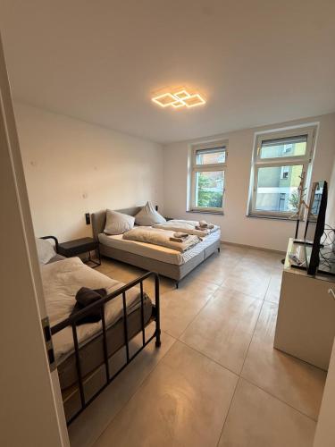 a large room with two beds and a couch at Am Zollverein House-In Apartments Essen - Free Parking - WiFi - Kitchen in Essen