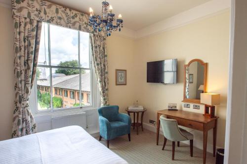 a hotel room with a desk and a window at Winchester Royal Hotel in Winchester
