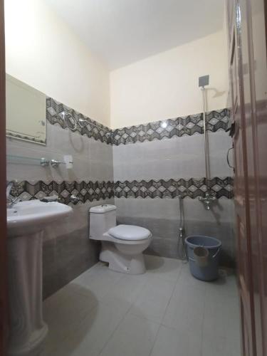 a bathroom with a toilet and a sink at Royal hotel jaglot gilgit in Gilgit