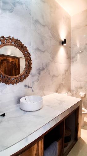 a bathroom with a sink and a mirror at Heritage Stay in Bingin Beach