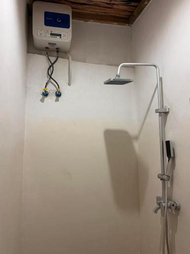 a bathroom with a machine on the wall at Mambo Leo Hostel in Paje