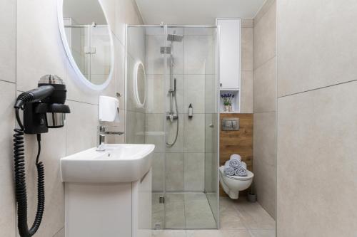 a bathroom with a shower and a sink and a toilet at ToTuLokum in Krakow