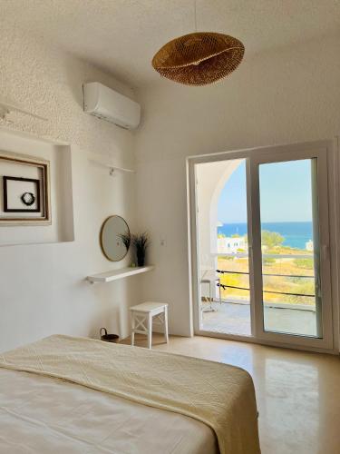 a bedroom with a bed and a view of the ocean at Aelia in Vári