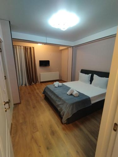 a bedroom with a bed with two towels on it at hotel G&G in Tsaghveri