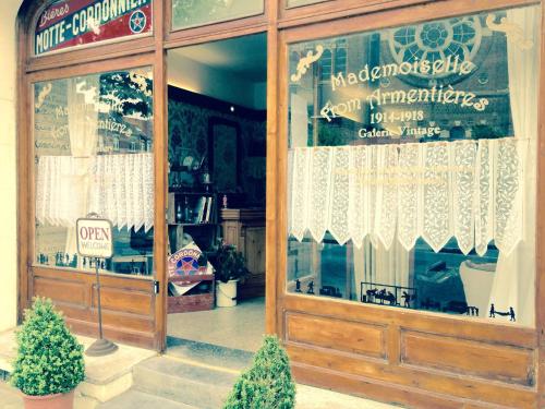 a store front with a sign in the window at Le 34 in Armentières