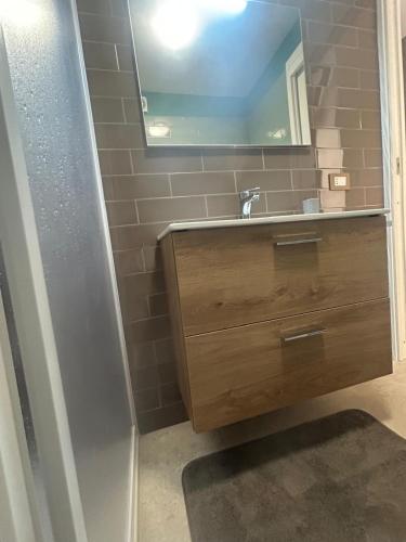 a bathroom with a sink and a mirror at Ciemme Apartments in Castellammare di Stabia
