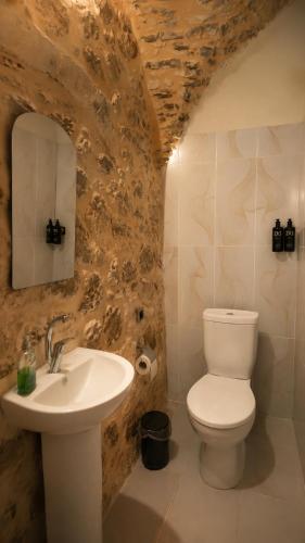 a bathroom with a white toilet and a sink at Terrace Merdin Konagı in Mardin