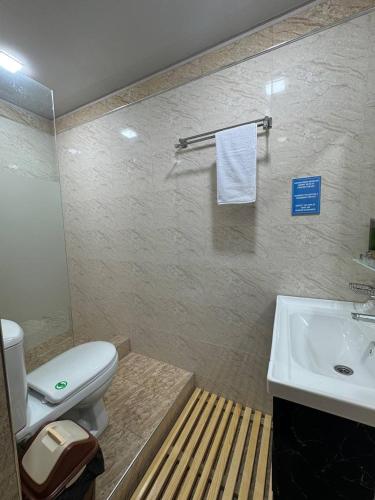 a bathroom with a toilet and a sink at Best Guest House in Andizhan