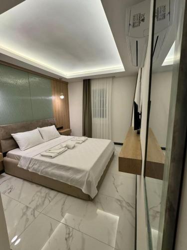 a hotel room with a bed and a glass window at Ydora Luxury Hotel in Bodrum City