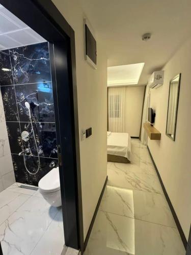 a room with a bathroom with a toilet in it at Ydora Luxury Hotel in Bodrum City