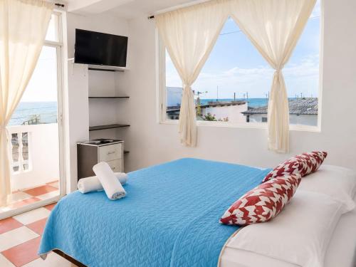 a bedroom with a bed with a view of the ocean at Terramar Hoteles in Crucita