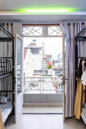 a room with bunk beds and a large window at Lumi living hostel in Ho Chi Minh City