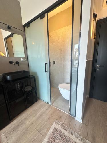 a bathroom with a shower and a toilet and a sink at L7 Urban Studios in Tel Aviv