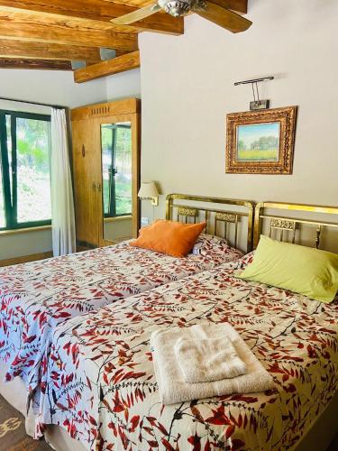 a bedroom with a large bed in a room at FINCA TIERRA CALMA Casa 1 in Hilario