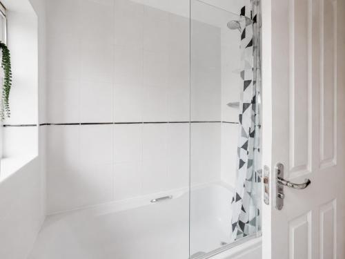 a shower with a glass door in a bathroom at 3 Bedroom House By Trinity Stays Short Lets & Serviced Accommodation Cambridge With Free WiFi & Parking in Cambridge