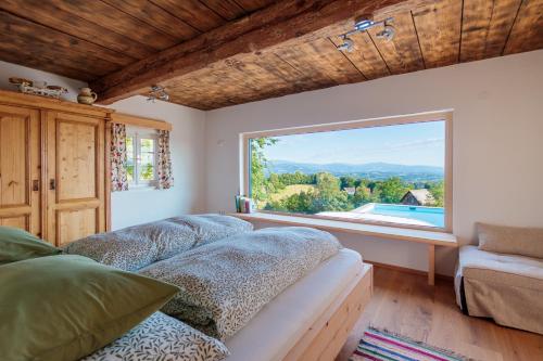 a living room with a couch and a large window at Ferienhaus Sterzhansl in Pongratzen