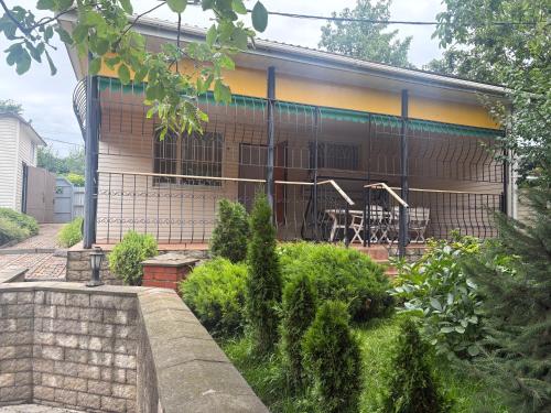 a house with a balcony with a table and chairs at Дом у моря in Odesa