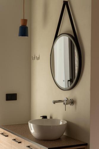 a bathroom with a white sink and a mirror at NINEMO Village in Fternón
