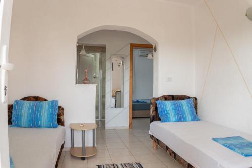 a living room with two beds and a bathroom at BEB House Ulcinj in Donji Štoj