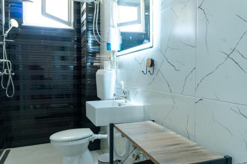 a bathroom with a white toilet and a sink at BEB House Ulcinj in Donji Štoj