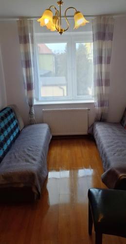 a living room with two couches and a window at Dziwnów 2 in Dziwnów