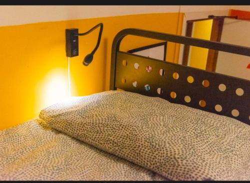 a bedroom with a bed with a black head board at Sunflower Beach Backpacker Hostel & Bar in Rimini