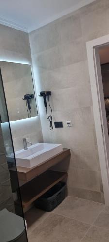 a bathroom with a sink and a mirror at House K and M in Pag